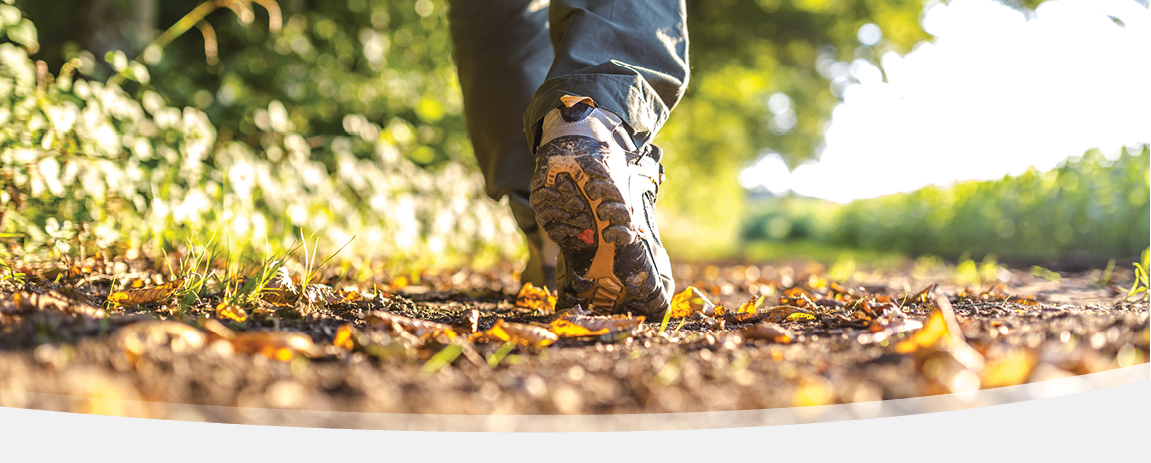 Hiking boots walking over leaves